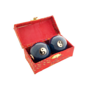 A Yin Yang health balls, often used in Tai Chi and traditional Chinese exercises, placed inside a decorative red box with gold details. The health balls feature the iconic black and white Yin Yang symbols and are designed to be rotated in the palm for meditation, stress relief, and hand muscle strengthening. The red box adds a traditional and elegant touch, enhancing the overall presentation of the set.